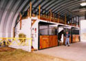 Armor Steel Buildings has Equestrian products to fit any budget.  The S-Series steel panel arch building allows for stalls to be constructed at the sides, without the interference of the large frames from the I-beam design.  The clear heights in the ceiling allows for the hay or additional storage in the loft.