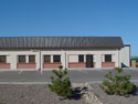 This Armor Steel Building is a professional office building, which features a 2' x3' mansard over sidewalls covered with Stucco and brick. The office building is attached to a larger warehouse.